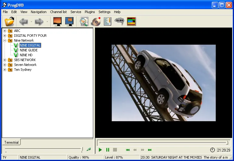 The ProgDVB window with a Windows XP title bar, a menu bar and a toolbar. A channel tree down the left lists ABC, DIGITAL FORTY FOUR, Nine Network expanded to NINE DIGITAL, NINE GUIDE and NINE HD, then SBS NETWORK, Seven Network and Ten Sydney. A car advertisement plays in the video pane on the right above transport controls. The status bar reads TV, NINE DIGITAL, Quality 98%, Level 87%, and 20:30 SATURDAY NIGHT AT THE MOVIES